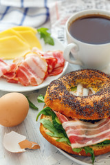 Bagel with a salad of arugula,cucumber and bacon for breakfast.