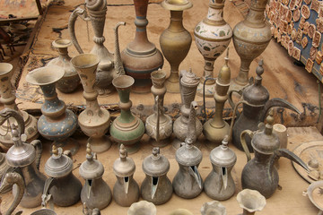 Fototapeta na wymiar Old metal bedouin coffee pots and jugs for water in one of the markets in Petra,Jordan
