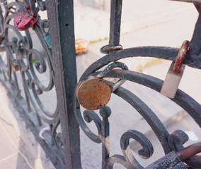 Old padlock on a decorative metal fence. Russian wedding tradition to attach the padlock as a symbol of love and loyalty