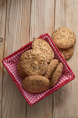 Savory cookies sprinkled with sesame seeds, sunflower on table and burlap background