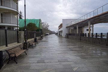 Empty embankment in a small resort town in the Crimea. Cloudy and rainy.