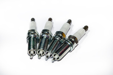 A spark plug is a device for igniting a fuel-air mixture in a wide variety of thermal engines. A set of spark plugs