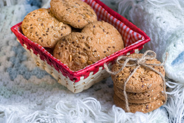 Savory cookies sprinkled with sesame seeds, sunflower on textile plaid