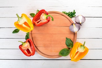 Fresh Bulgarian pepper. Paprika. On a wooden background. Top view. Copy space.