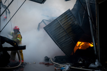 Chernivtsi / Ukraine - 03/19/2018: Firefighters on fire. Fireman extinguishes the fire with water....