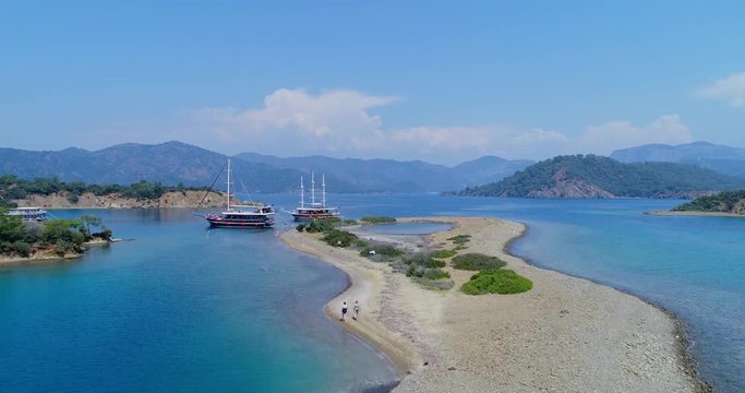 Amazing aerial view of picturesque gulf with crystal clear blue water. Flat island, Turkey. 4K.