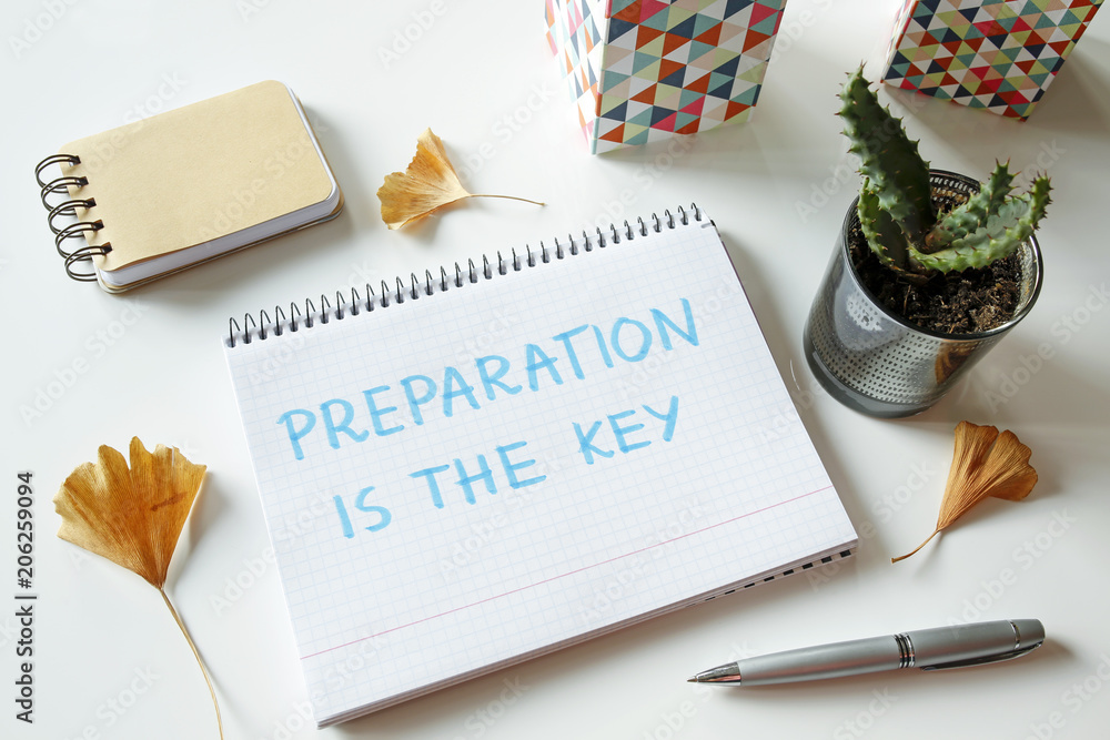 Poster preparation is the key written in notebook on white table
