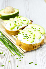 Avocado toast on wooden mat. Healthy diet concept.