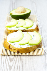 Avocado toast on wooden mat. Healthy diet concept.