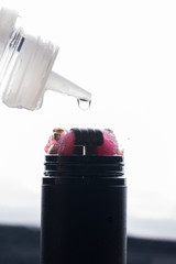 Closeup of an electronic cigarette with a drop of liquid