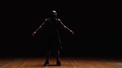 A basketball player receives a pass and passes it again behind his back