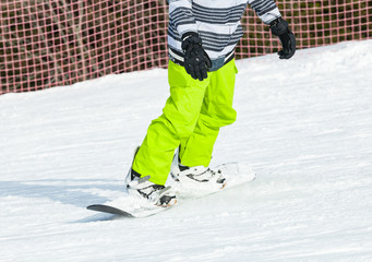 Snowboarder snowboarding on fresh snow
