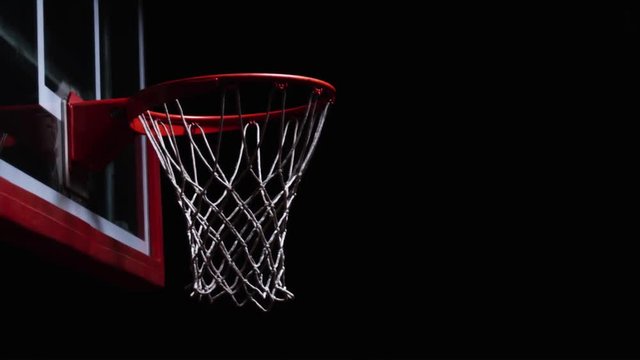 Close up of backward slam dunk on a hoop