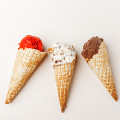 A set of ice cream in a horn with different flavors.