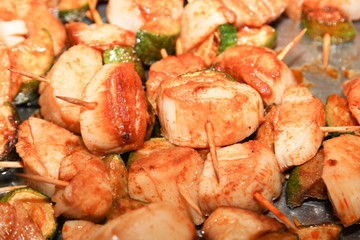 small pieces of chicken meat and pork on peaks