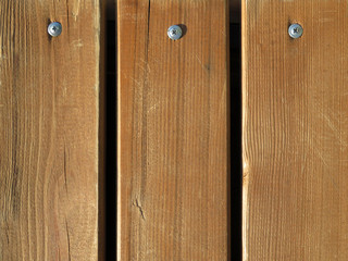Wood flooring, wooden boards with screws. Unpainted bench texture, old panels background