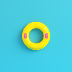 Yellow inflatable ring on bright blue background in pastel colors - obrazy, fototapety, plakaty