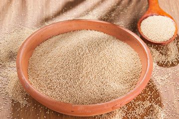 Raw Organic Amaranth grain on wooden table