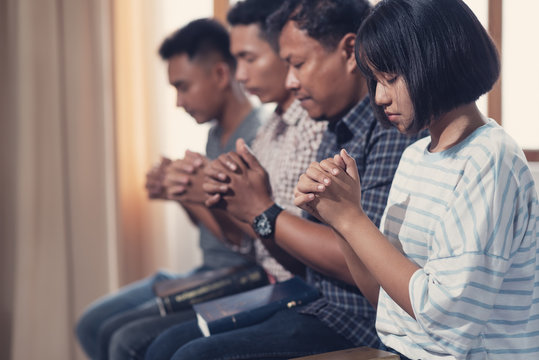 Christians and Bible study concept. Group of discipleship Studying the Word Of God in church and Christians praying together