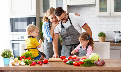 happy family with children preparing vegetable salad