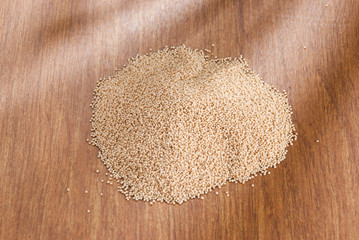 Raw Organic Amaranth grain on wooden table