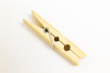 Natural wooden clothes pin on white background
