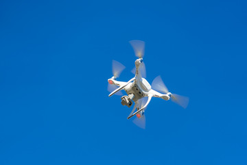White flying copter against the sky