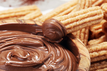 Traditional Spanish dessert churros with sugar and chocolate
