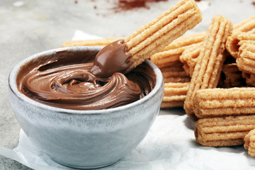 Traditional Spanish dessert churros with sugar and chocolate