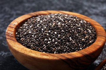 Healthy Chia seeds in a wooden spoon on the table close-up