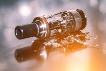 Broken vaping on the table with small pieces of glass. broken glass tank