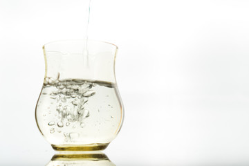 Close up of a fresh drink of water from a bottle in the studio on a white background