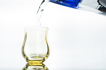 Close up of a fresh drink of water from a bottle in the studio on a white background