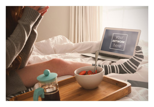 Laptop User Having Breakfast in Bed Mockup