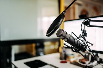 Close-up image of microphone in podcast studio. - obrazy, fototapety, plakaty