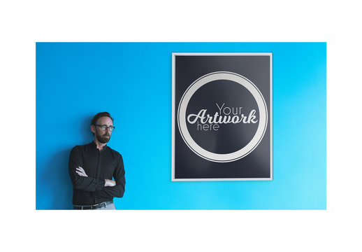 Man with White Frame Canvas on Blue Wall Mockup