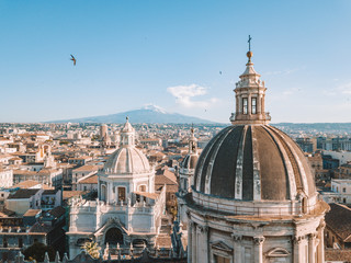 Aerial view of the Cathedral of Sant'Agata in the middle of Catania with Etna volcano on the...