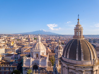 Aerial view of the Cathedral of Sant'Agata in the middle of Catania with Etna volcano on the background