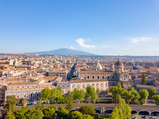Aerial view of the Cathedral of Sant'Agata in the middle of Catania with Etna volcano on the background
