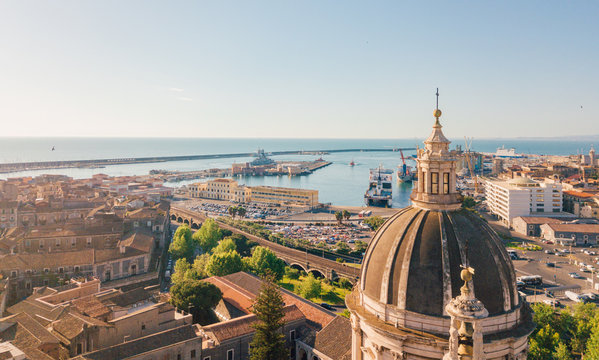 Aerial view of the Cathedral of Sant'Agata in the middle of Catania with Etna volcano on the background