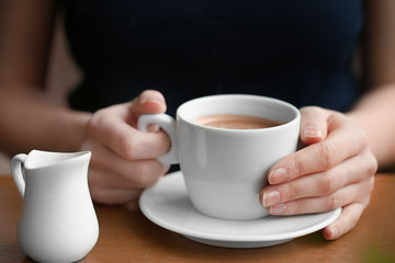 Woman with cup of aromatic coffee, closeup
