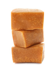 Delicious caramel candies on white background