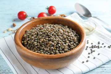 Dish with tasty lentil porridge on table