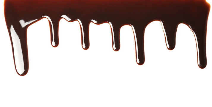 Delicious melted chocolate flowing on white background