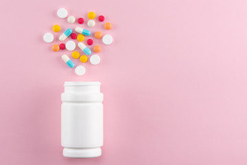 colorful pills spilling out of the medicine bottle with copy space