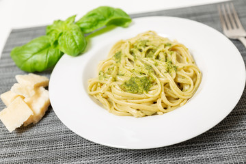 Linguine (or Trenette) with Genovese pesto sauce, a typical sauce of the Liguria region (Italy). The basil is the fundamental ingredient of this delicious sauce together with Parmesan cheese.