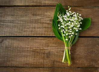 lilly of the valley flowers on wooden surface