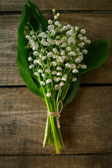 lilly of the valley flowers on wooden surface