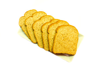 Slices of wholemeal bread on a white background viewed from above