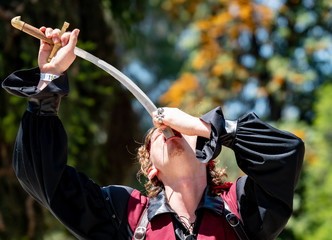 Handsome Sword Swallower Performs Act at Pirate Festival